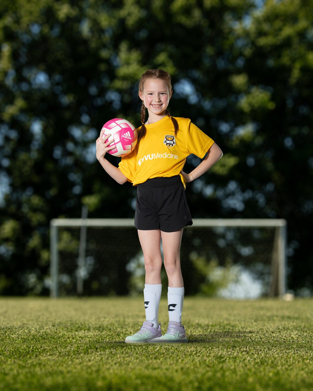 Full-body composite of a youth soccer player on the field by DLS Innovations