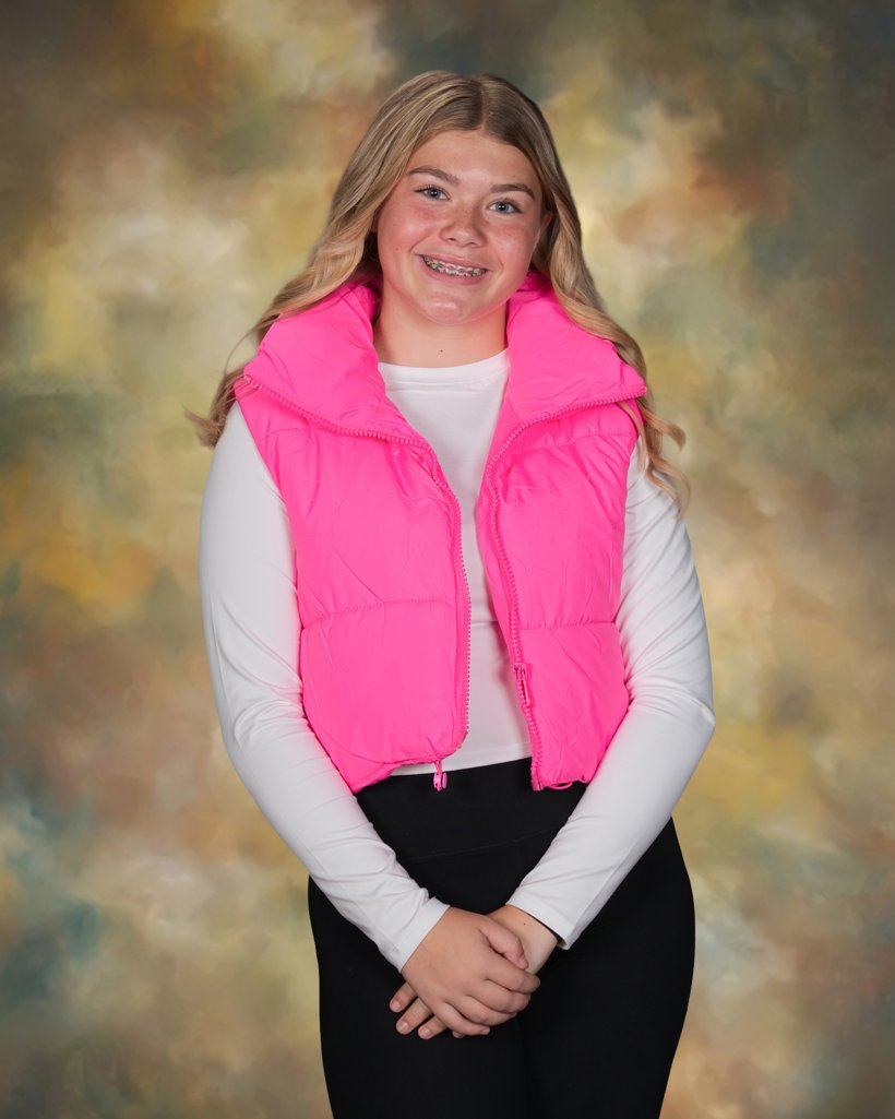 A DLS Innovations school portrait on a painterly studio background