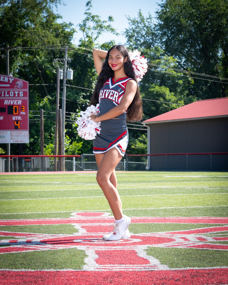 A DLS Innovations cheerleading portrait of a River cheerleader on the field